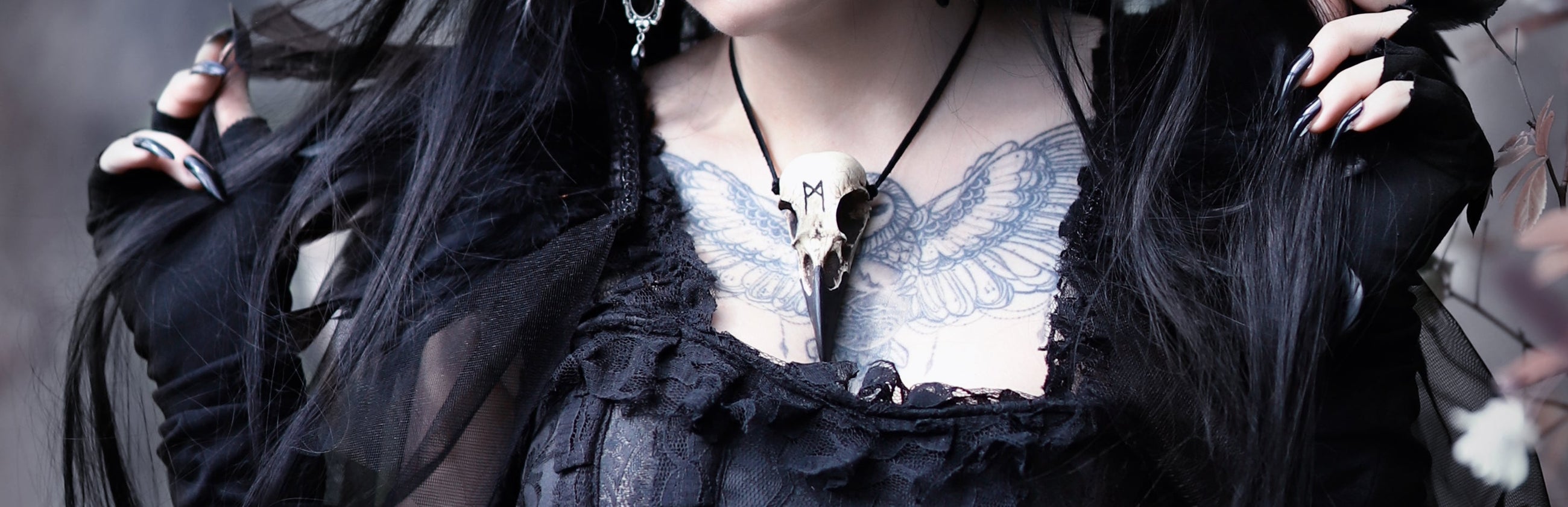 goth model with tattoo wearing raven skull necklace from raven ranch studio