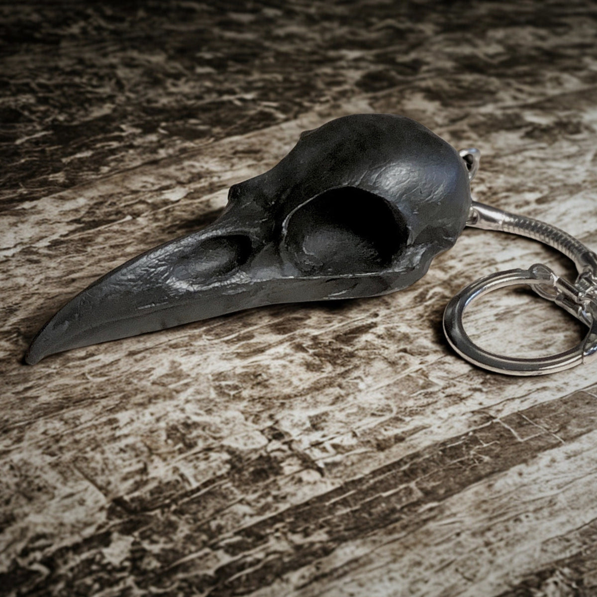 2.75 inch raven skull biker style keychain made of spooky black resin to look like a real bird skull key chain.