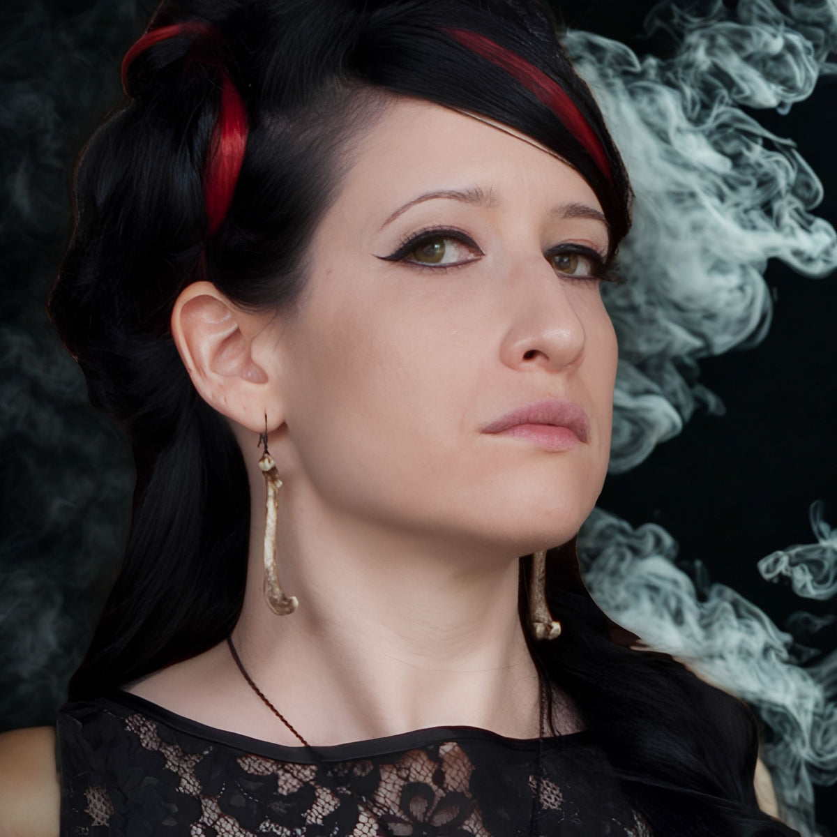 Alt model wearing resin femur bone dangle earrings that are handmade by Raven Ranch Studio, an expert resin skull artist.