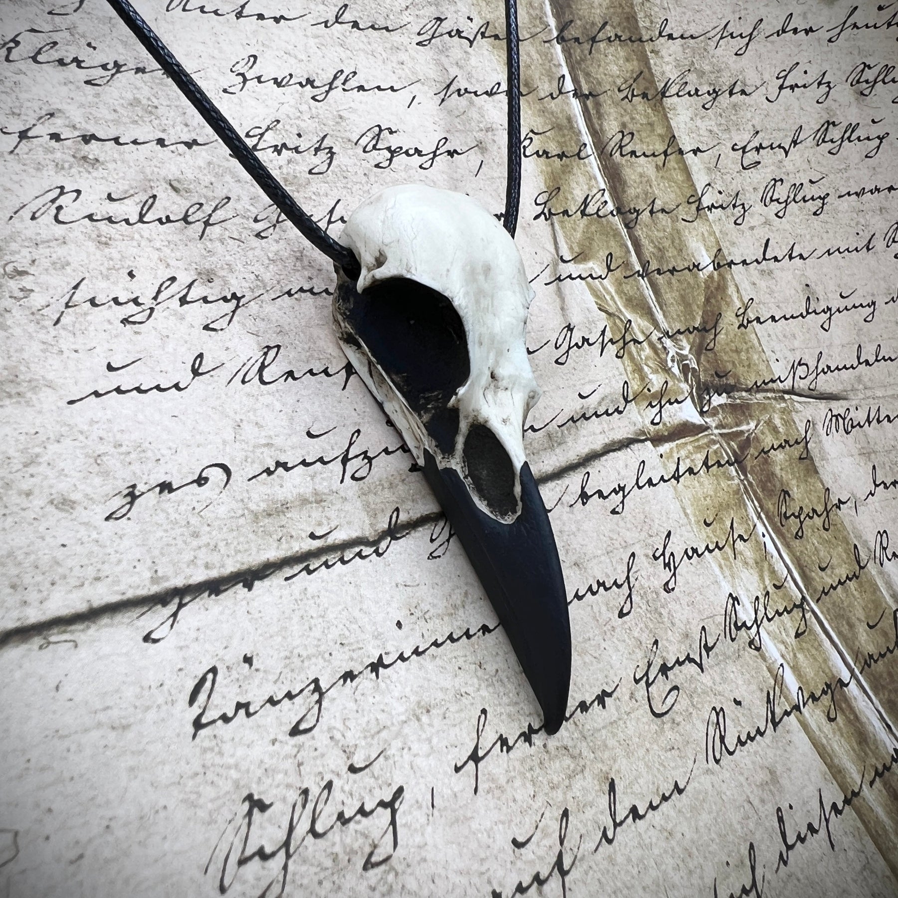 Viking raven skull pendant for men and women made by resin bone jewelry artist Raven Ranch Studio.
