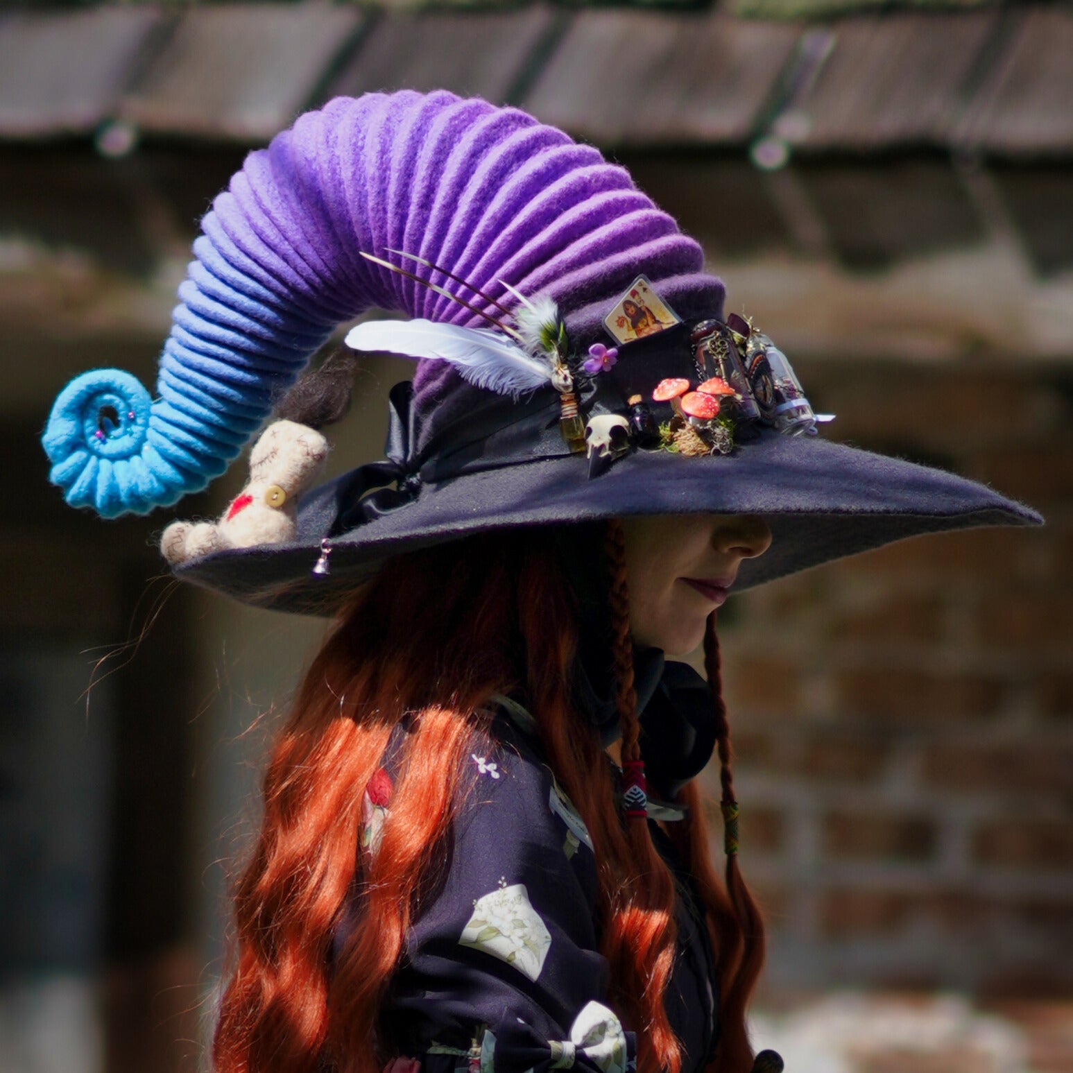 Raven skull hat pin worn by colorful witch on her witchy hat