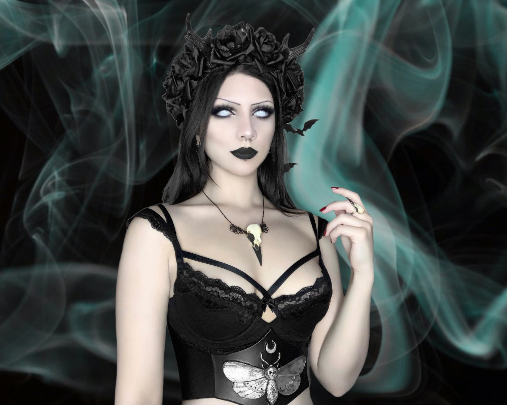 Luna goth girl wearing a celestial moth raven skull bone jewelry necklace with butterflies and crescent moons.