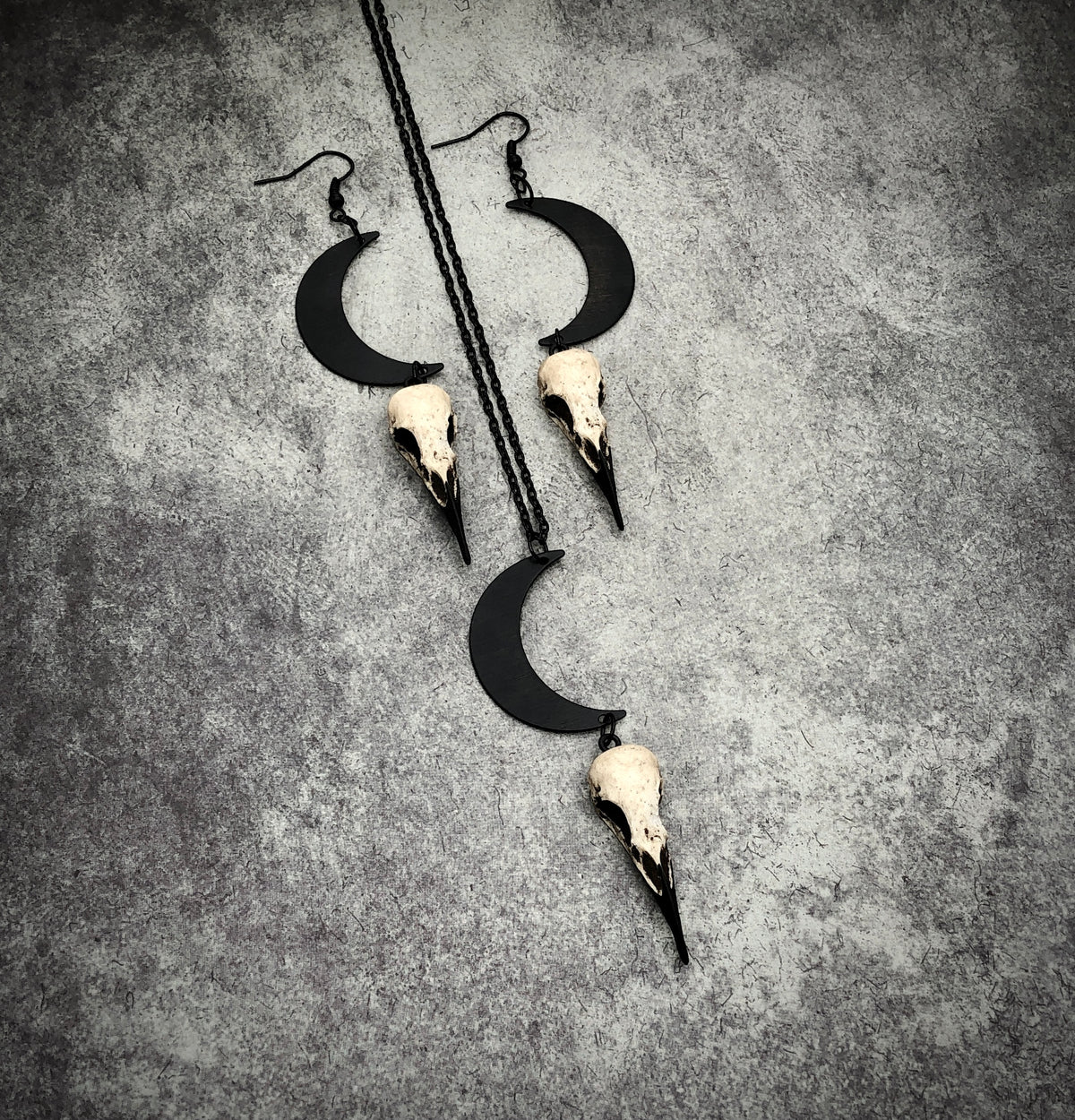 Bone jewelry necklace and dangle earring set of crescent waxing waning moon raven goth lunar skull charm and bird skull.