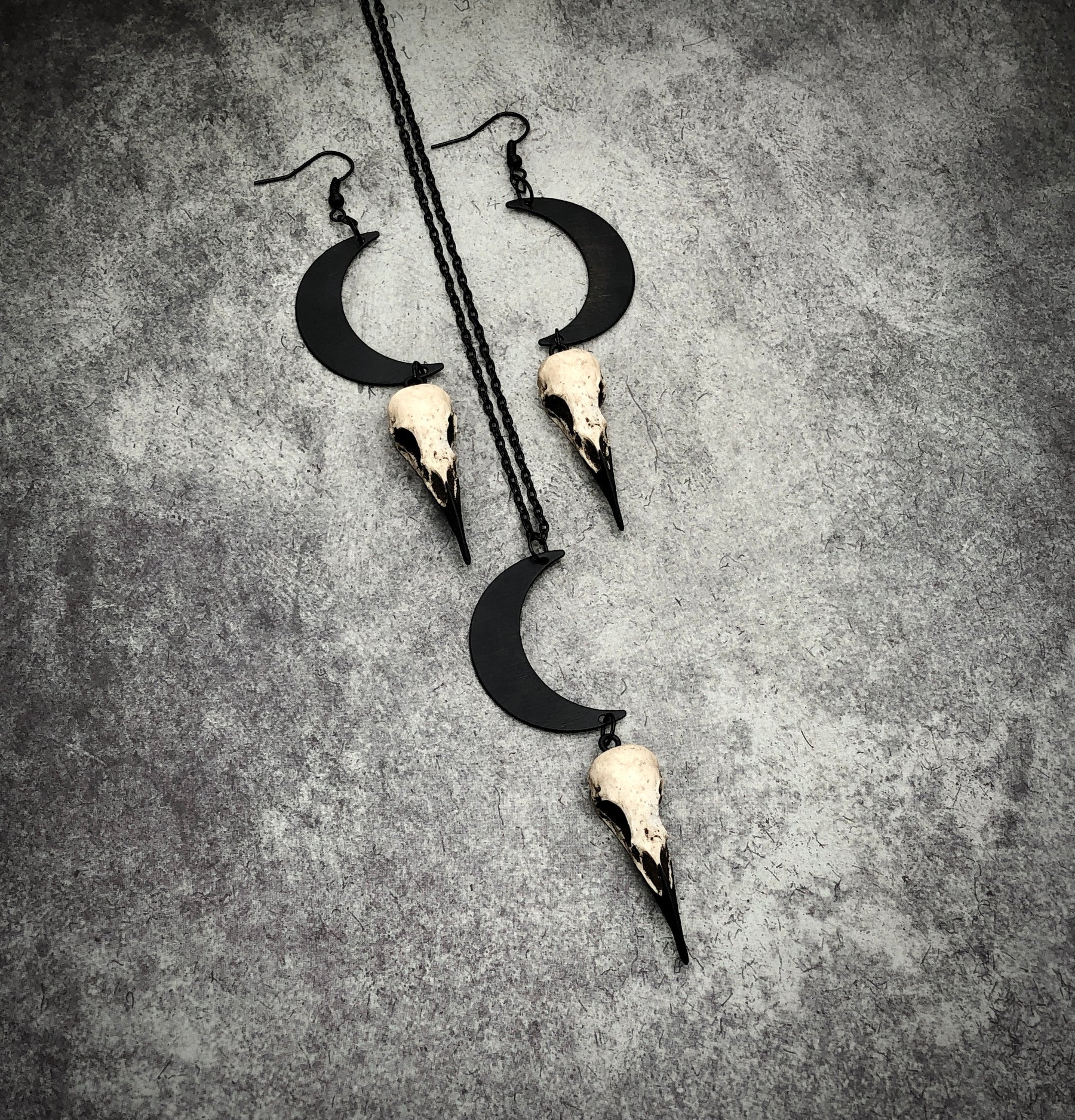 Bone jewelry necklace and dangle earring set of crescent waxing waning moon raven goth lunar skull charm and bird skull.