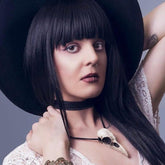 Bird skull pendant 3.5 inch extra large resin raven skull necklace in an aged patina finish being worn by alternative style model.