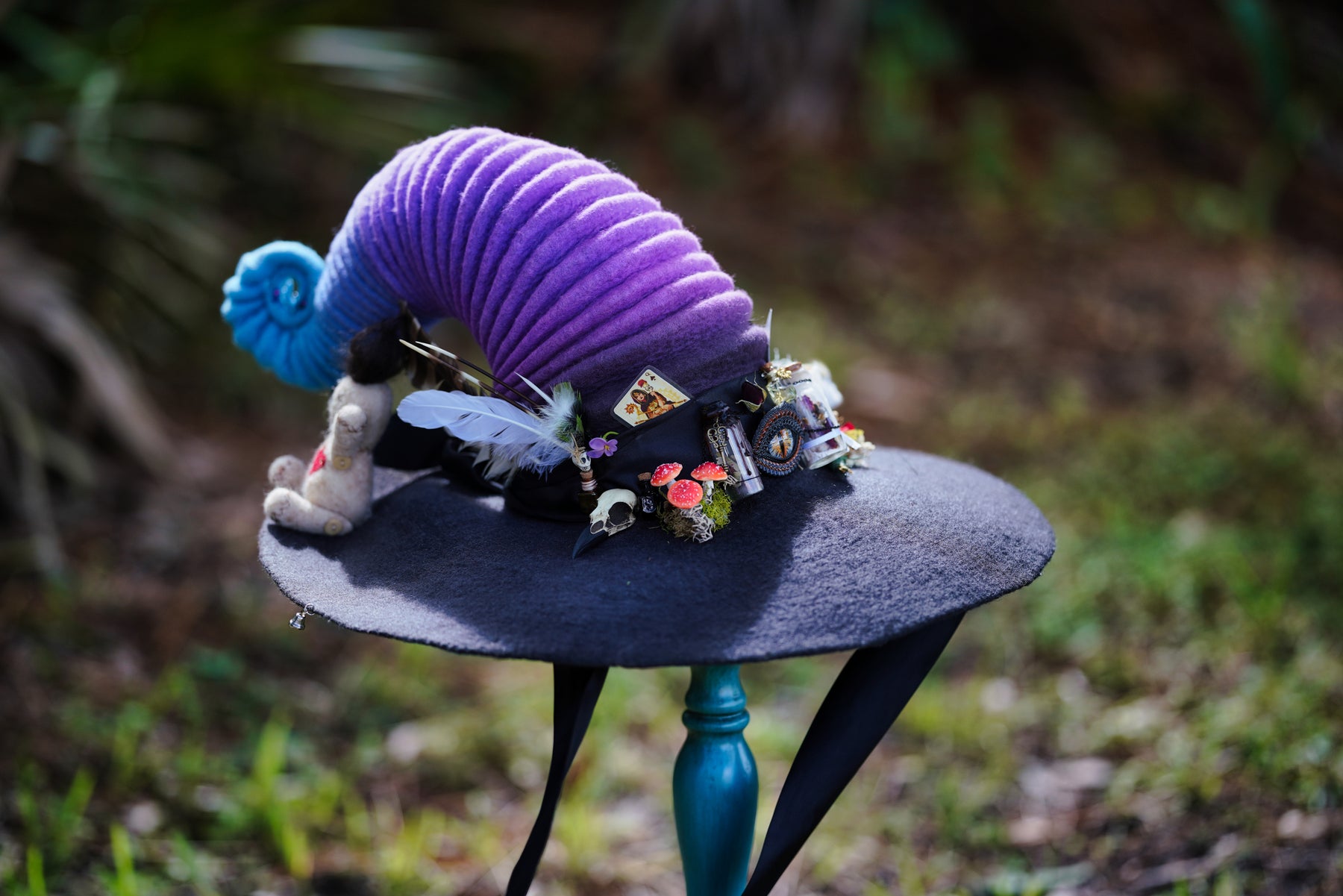 rainbow witch cosplay ren faire hat with a creepy unique bird skull raven hat pin brooch giving it a Halloween funky look.