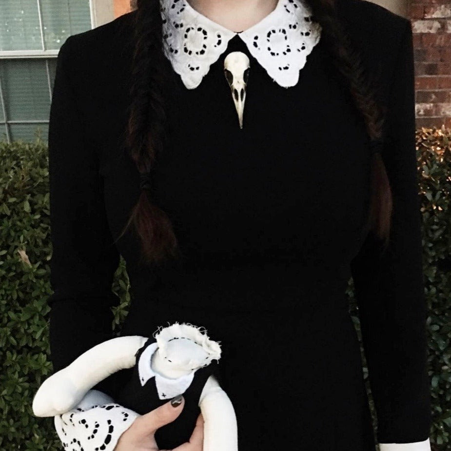 Wednesday addams bird skull necklace bone raven skull jewelry worn by gothic girl.