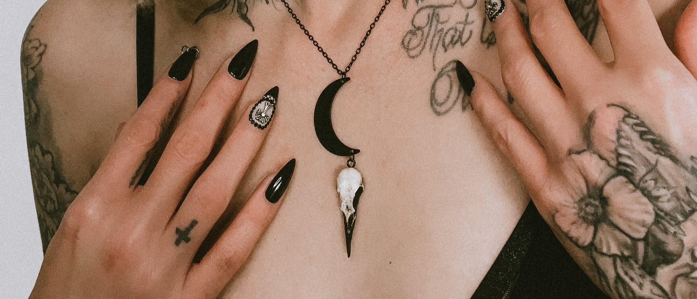crescent moon lunar raven skull necklace worn by tattooed model