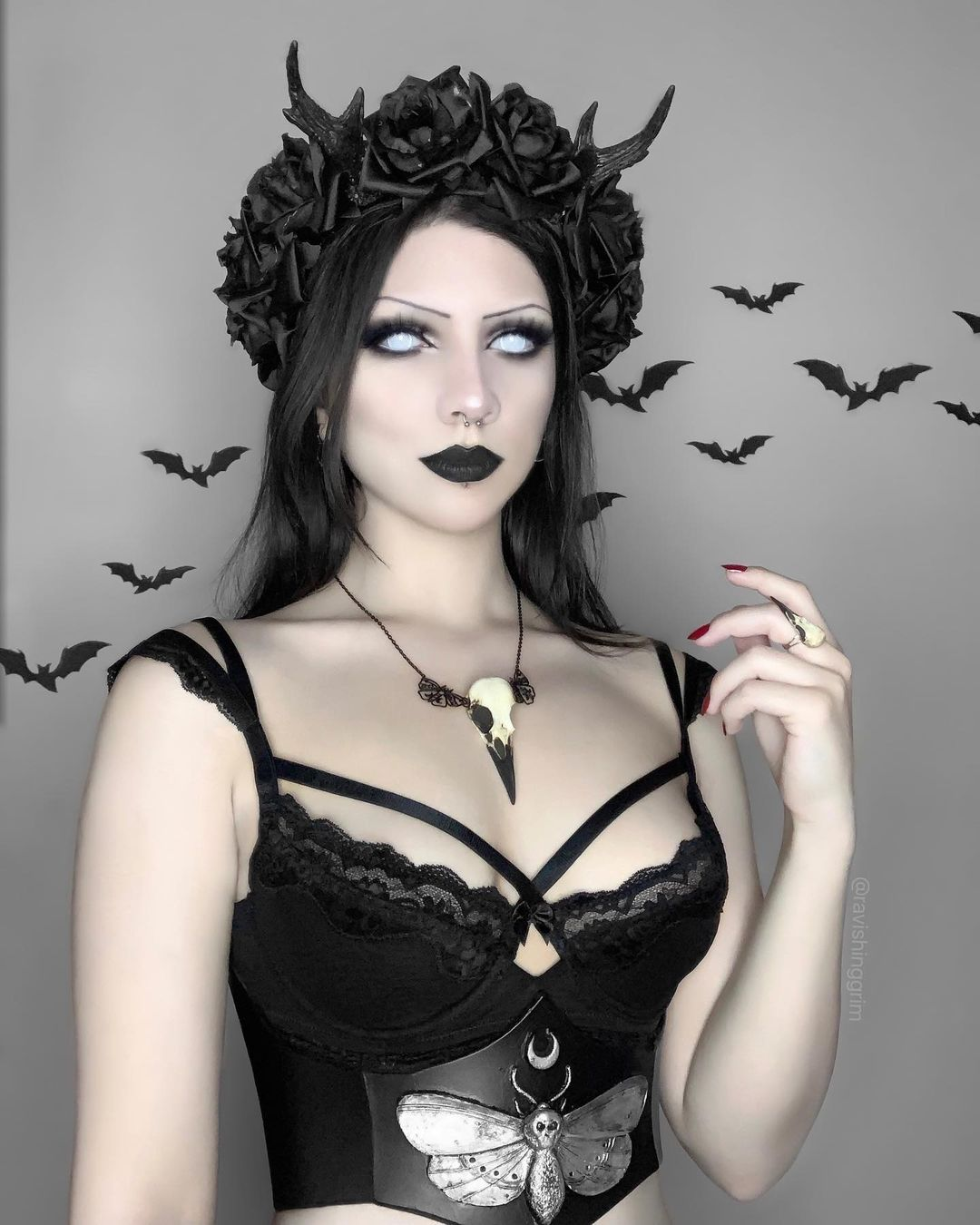 raven skull necklace bird skull jewelry worn by gothic model with black bats and a moth