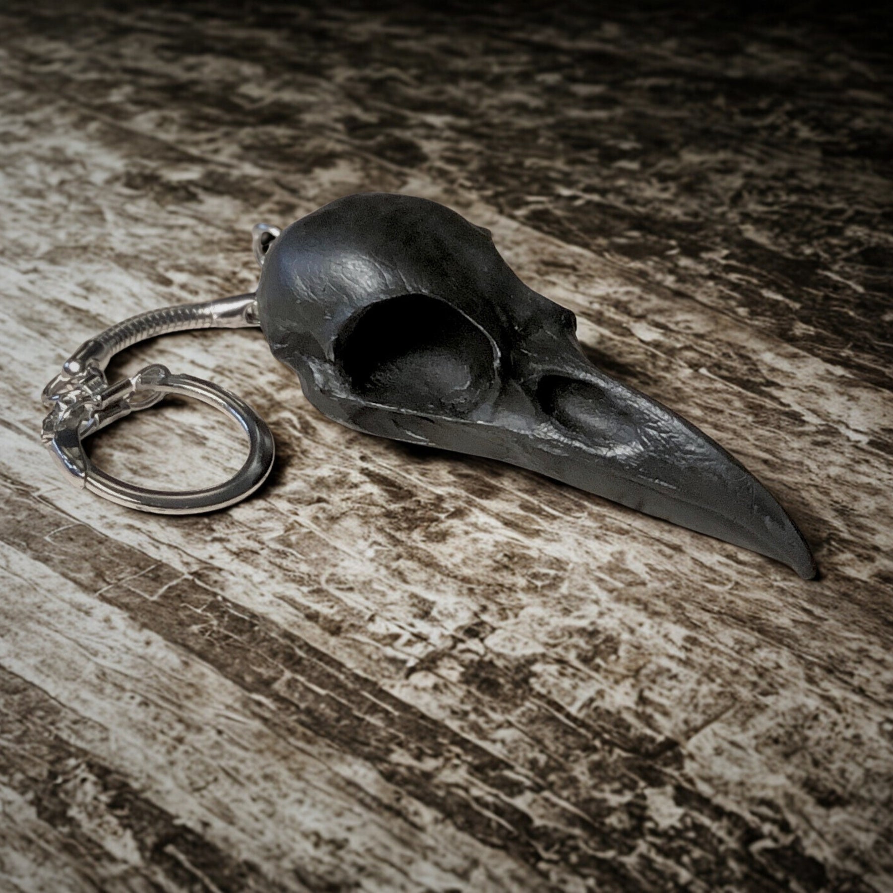 2.75 inch raven skull biker style keychain made of spooky black resin to look like a real bird skull key chain. 