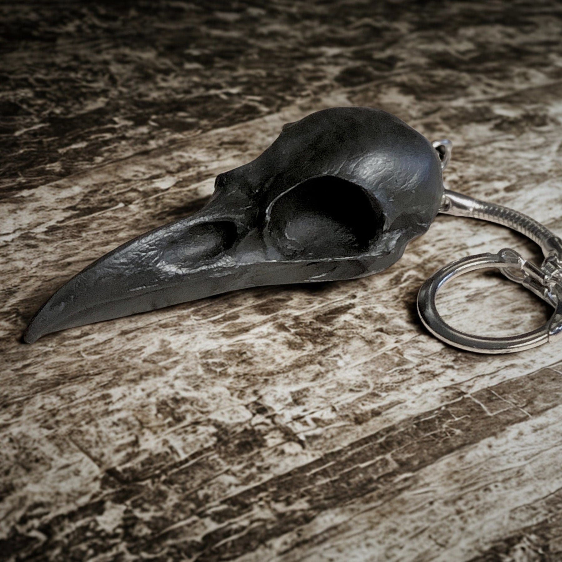 2.75 inch raven skull biker style keychain made of spooky black resin to look like a real bird skull key chain. 