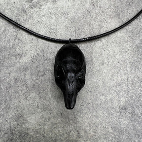 Front and top close up view of a bone jewelry black resin rat skull necklace pendant for goths that love Halloween and taxidermy accessories.