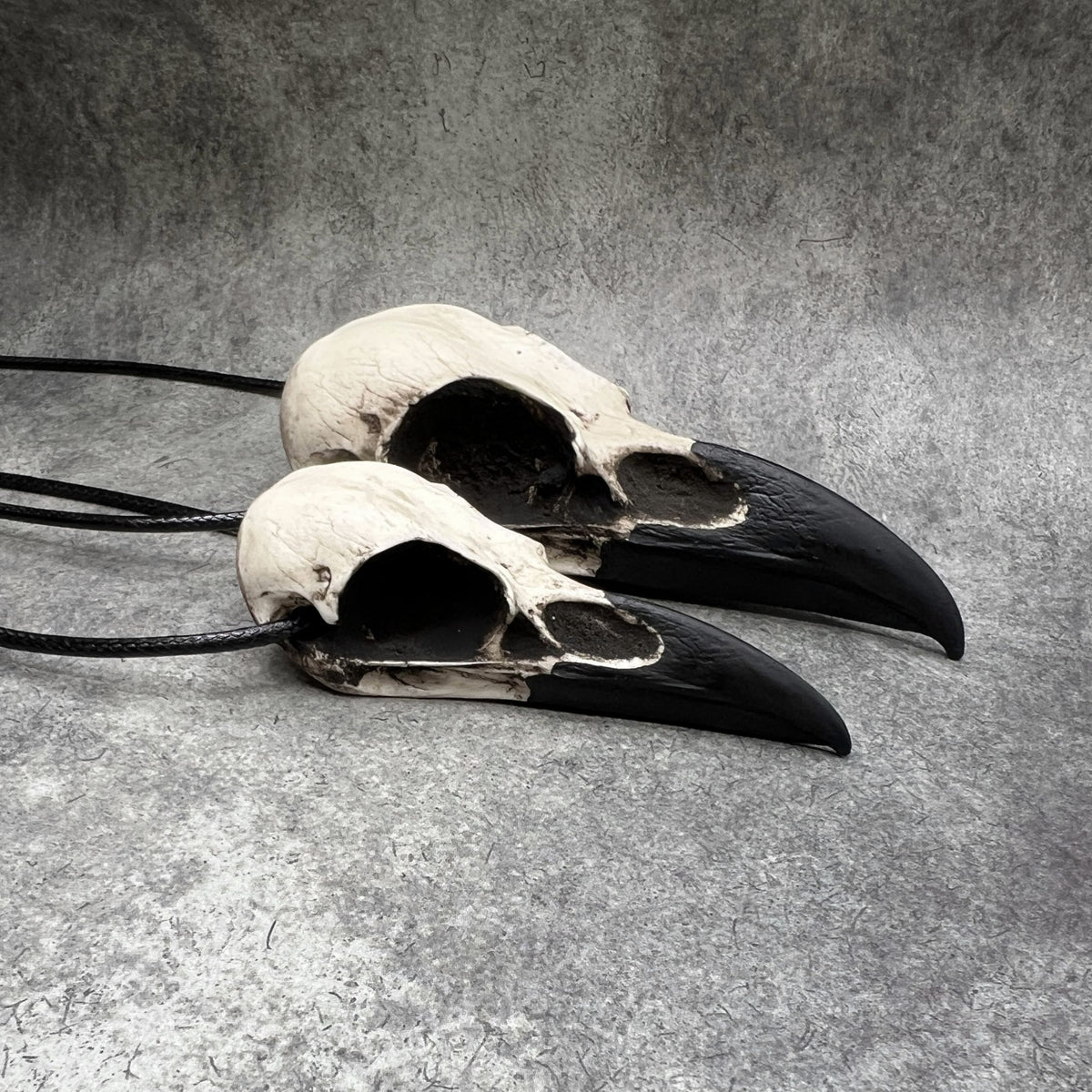 Large life size resin raven skull necklace pendant bone jewelry and a mini raven animal skull that are sold as a goth gift set.
