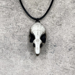 Front view of a bone jewelry aged patina resin rat skull necklace pendant for goths that love Halloween and taxidermy accessories.