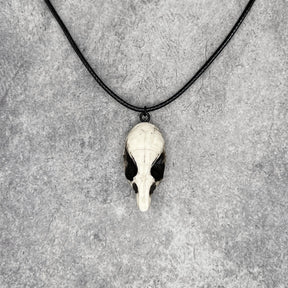 Front view of a bone jewelry aged patina resin rat skull necklace pendant for goths that love Halloween and taxidermy accessories.