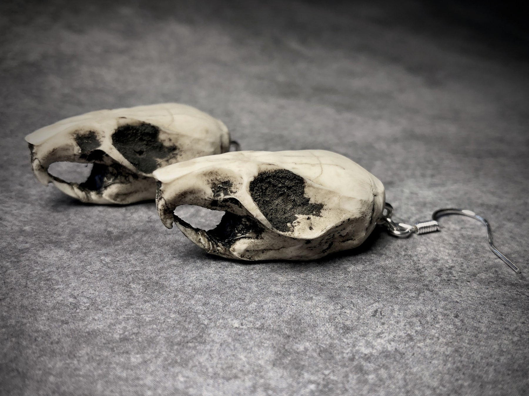 resin rat skull dangle earrings for goths that love bone jewelry, creepy accessories, witchy style and Halloween jewelry.
