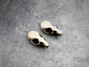 resin rat skull dangle earrings for goths that love bone jewelry, creepy accessories, witchy style and Halloween jewelry.
