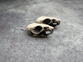 resin rat skull dangle earrings for goths that love bone jewelry, creepy accessories, witchy style and Halloween jewelry.