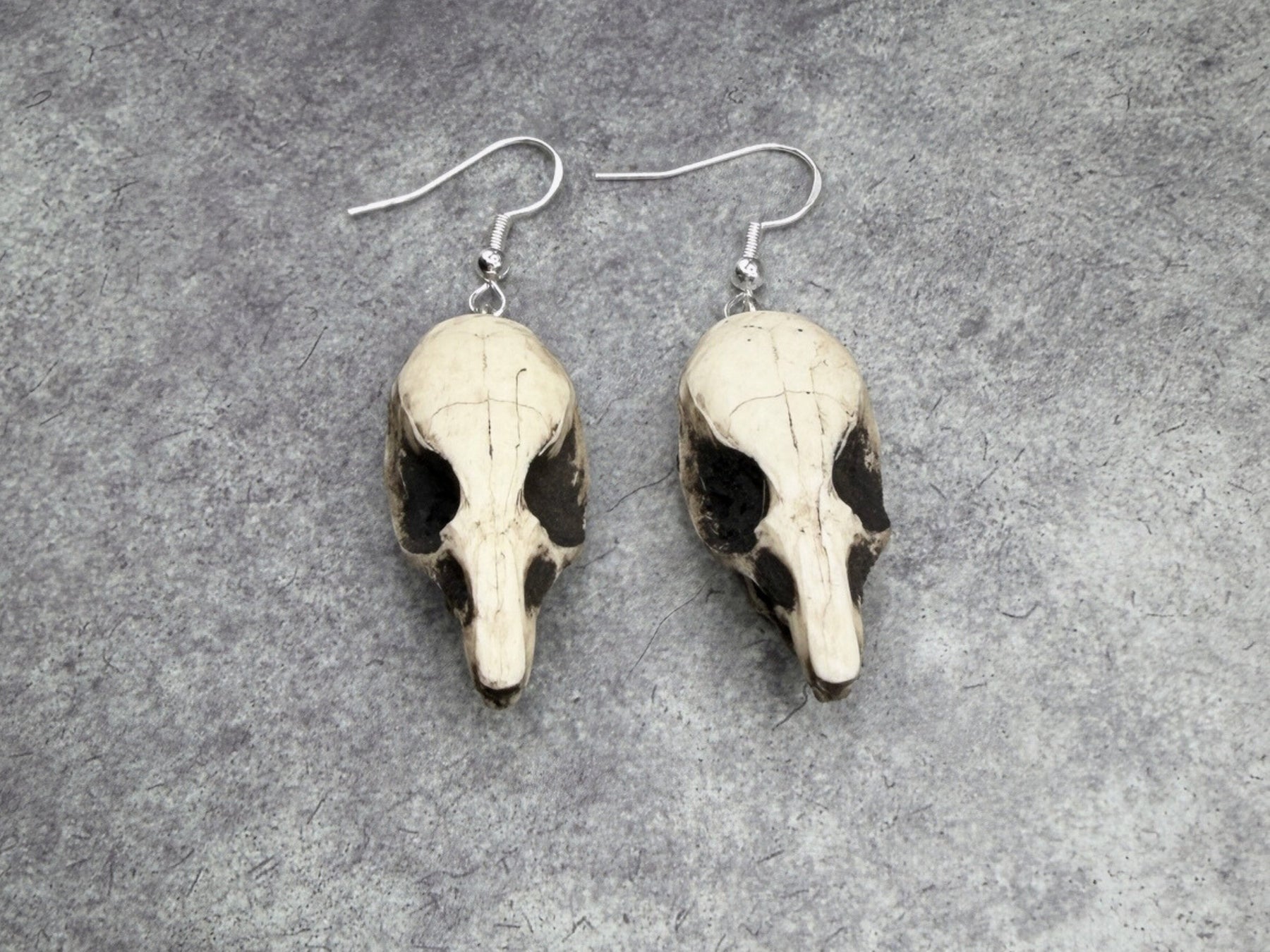 resin rat skull dangle earrings for goths that love bone jewelry, creepy accessories, witchy style and Halloween jewelry.