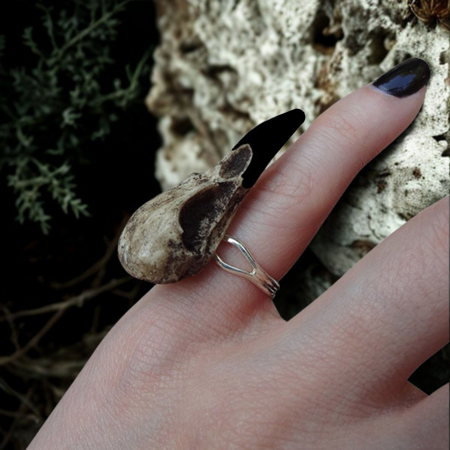 Gothic bird skull witchy style resin raven skull ring. A miniature raven skull ring that is a bird skull jewelry accessory for goths, ren faire, festivals and halloween costumes. The skull has a patina aged finish with black beak.