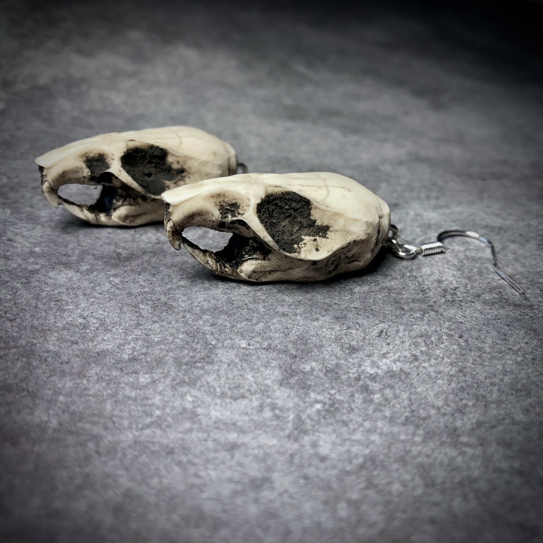 resin rat skull dangle earrings for goths that love bone jewelry, creepy accessories, witchy style and Halloween jewelry.