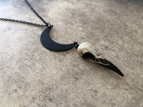 raven skull mini charm pendant necklace with lunar crescent moon and black chain, a bff goth gift idea for Halloween.
