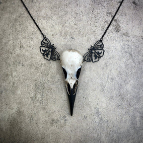 Bone jewelry luna moth raven skull necklace featuring black crescent moon moth charms and a realistic resin bird skull.
