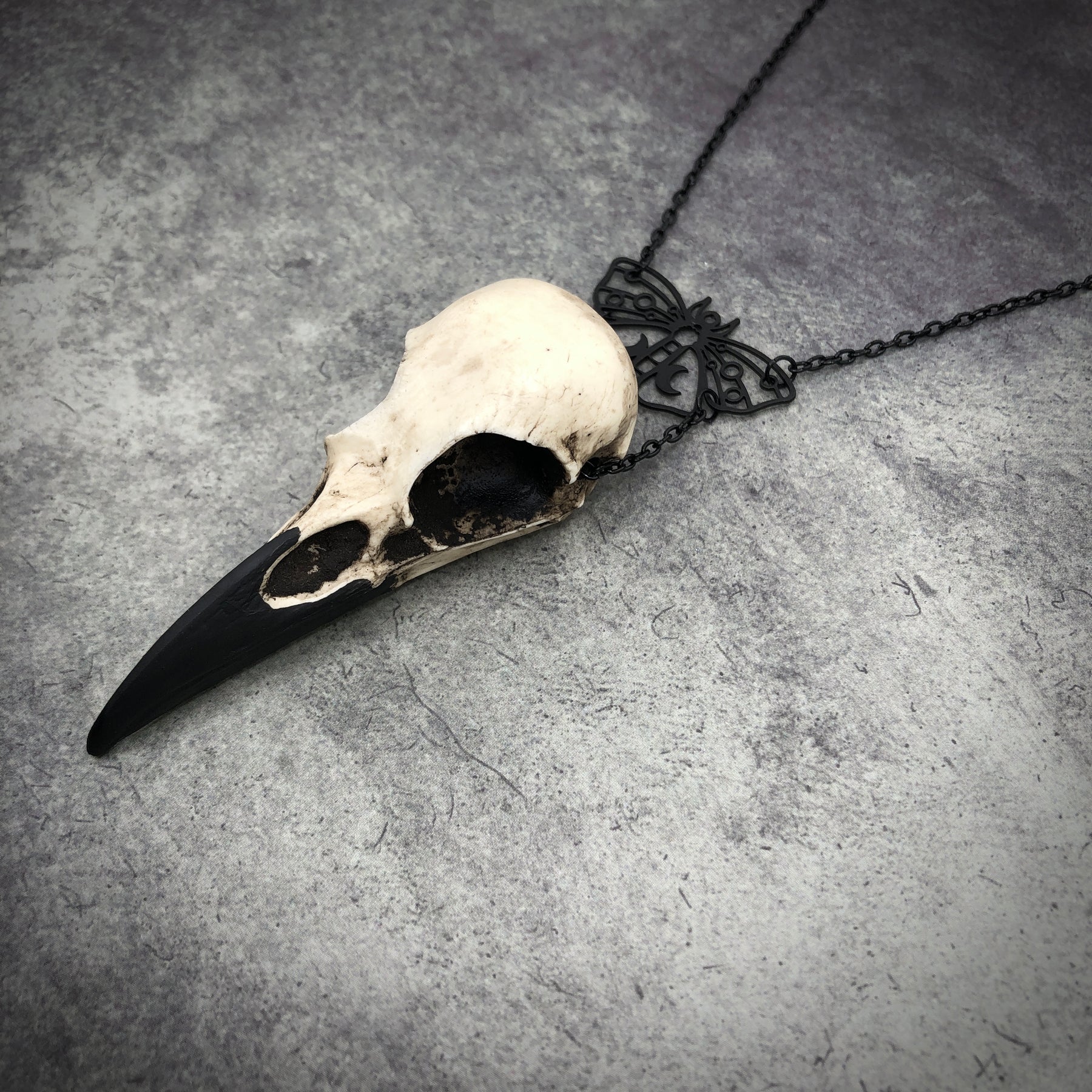 Cottagecore gothic black death moth luna butterfly charm pendant and bone jewelry mini raven skull dangle pendant by artist making resin bird skulls.