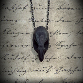 Front view of a bone jewelry black resin rat skull necklace pendant for goths that love Halloween and taxidermy accessories.